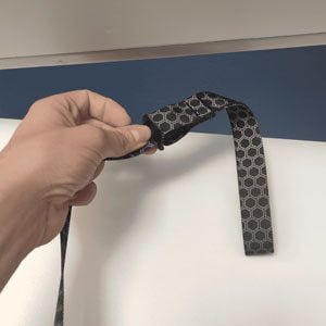 The Body Wisdom Sling Trainer Anywhere Anchor used as a door anchor- opening of the door and setting up the door anchor